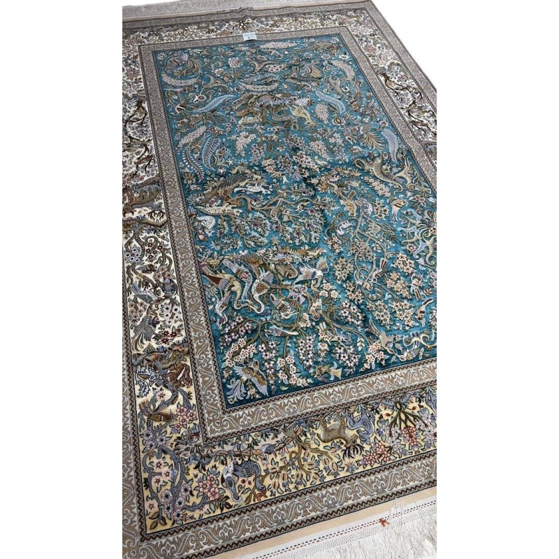 "Handmade Persian carpet from Isfahan – elegant silk and wool area rug with detailed Persian hunting design."