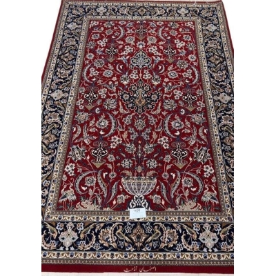 "Hand-knotted Isfahan Persian rug crafted by Ghenaat, featuring wool and silk in a luxurious red and black design. Measuring 170 cm x 110 cm (5.6 ft x 3.6 ft) with a knot density of 810,000 knots per square meter, this exquisite Persian carpet showcases intricate craftsmanship. Available for purchase online with only one rug in stock."
