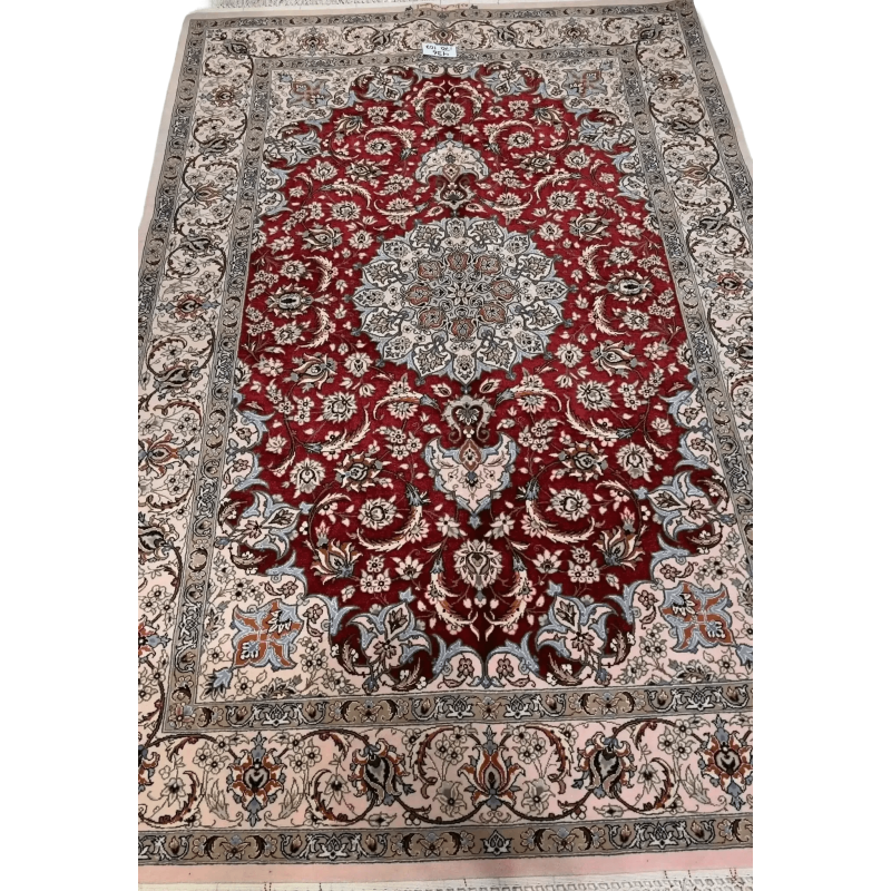 "Authentic Isfahan Persian rug woven by master artisan Taghiezadeh. This silk and wool area rug, measuring 170 cm x 107 cm, offers intricate craftsmanship with a knot density of 810,000 knots per square meter. Buy this luxurious Persian carpet online to add elegance to any space."
