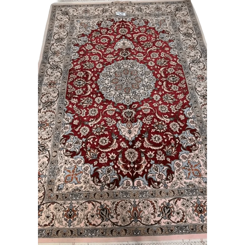 "Authentic Isfahan Persian rug woven by master artisan Taghiezadeh. This silk and wool area rug, measuring 170 cm x 107 cm, offers intricate craftsmanship with a knot density of 810,000 knots per square meter. Buy this luxurious Persian carpet online to add elegance to any space."