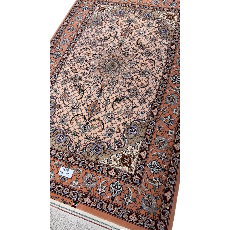 Elegant Isfahan rug featuring a central medallion and soft peach background.