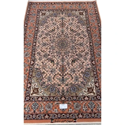 Hand-knotted Persian rug from Isfahan with peach tones and floral motifs.
