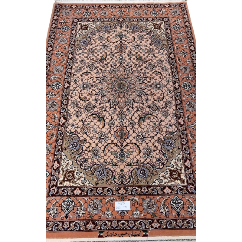 Hand-knotted Persian rug from Isfahan with peach tones and floral motifs.