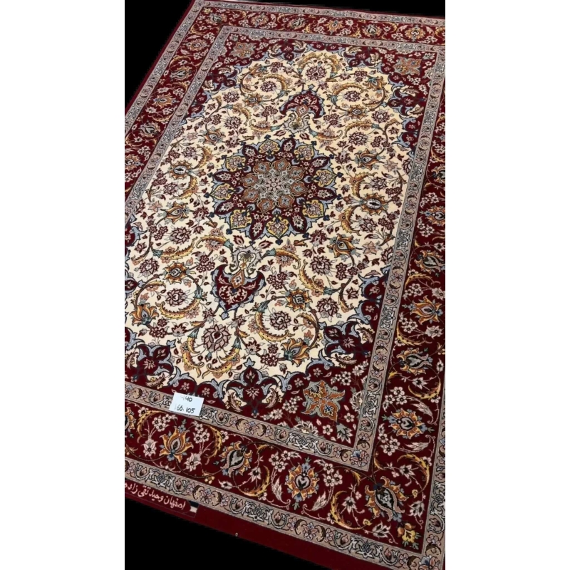 "Elegant wool and silk Persian rug from Isfahan, hand-knotted by master weaver Taghiezadeh. This luxurious 166 cm x 105 cm rug adds timeless beauty to any space."