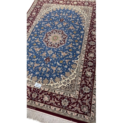 Classic Persian rug in red and blue with a central medallion and floral motifs
