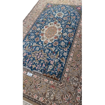Persian rug featuring floral motifs on a blue background.