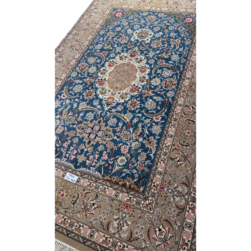 Persian rug featuring floral motifs on a blue background.