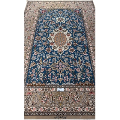 Isfahan hand-knotted rug in blue with a central medallion design.
