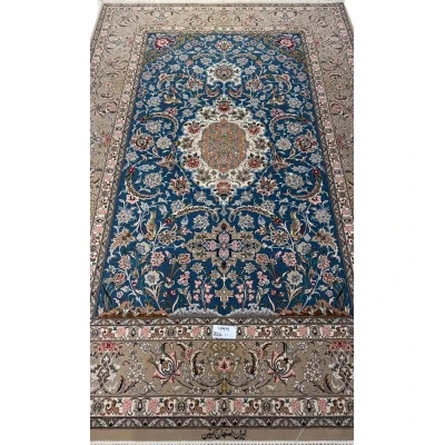 Isfahan hand-knotted rug in blue with a central medallion design.
