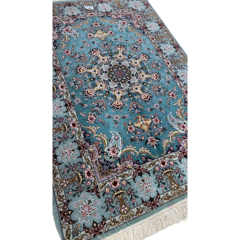 Luxurious wool and silk Persian rug featuring a teal and light blue color scheme.