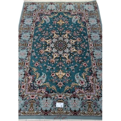 Hand-knotted Isfahan Persian rug with teal background and floral medallion.
