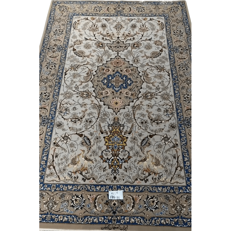 "Light grey Persian Isfahan rug, handcrafted using wool and silk. Elegant designer area rug with intricate details, measuring 170 cm x 110 cm. High knot density for added comfort and beauty."