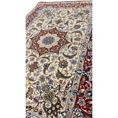 "Close-up of a Persian Isfahan rug with intricate red and ivory floral patterns."