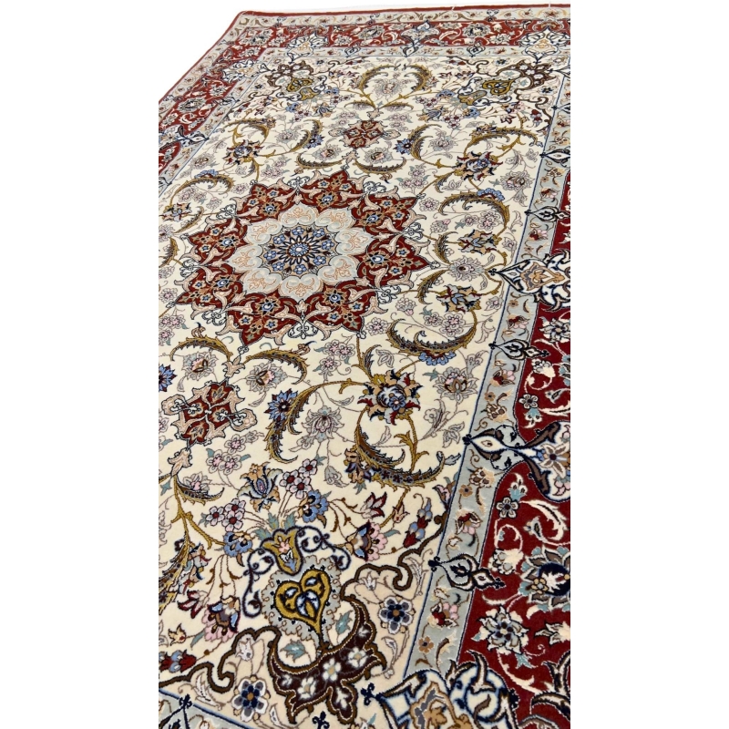 "Close-up of a Persian Isfahan rug with intricate red and ivory floral patterns."