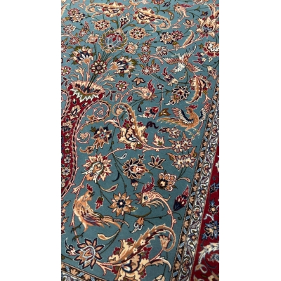 "Close-up view of the intricate floral patterns on the light blue Persian rug by Master Zojajie, highlighting the hand-knotted silk and wool craftsmanship."