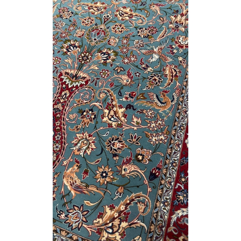 "Close-up view of the intricate floral patterns on the light blue Persian rug by Master Zojajie, highlighting the hand-knotted silk and wool craftsmanship."