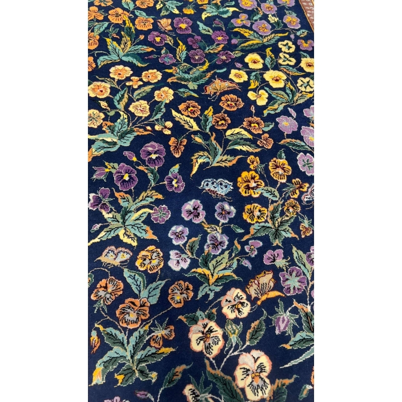 Elegant Persian rug featuring intricate floral and garden motifs.