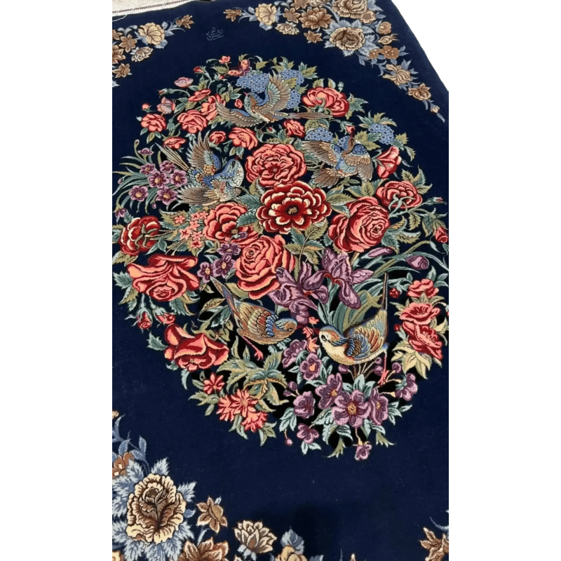 Close-up of the detailed floral embroidery on a navy Persian Isfahan rug