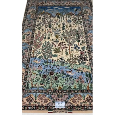 "Luxury Persian carpet from Isfahan, Iran, made of silk and wool with floral, river, and wildlife motifs."