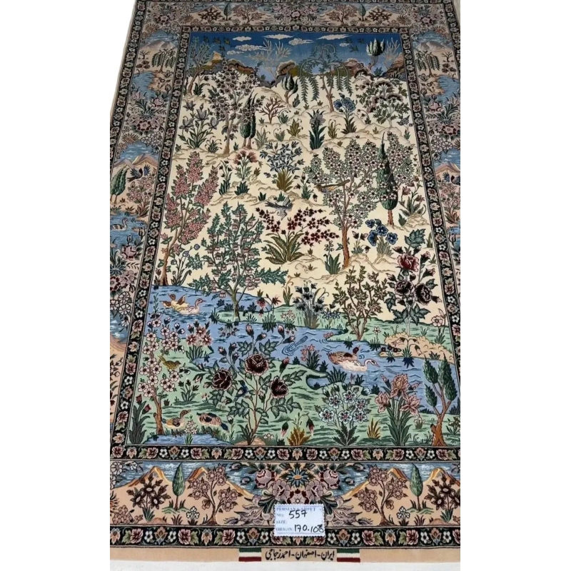 "Luxury Persian carpet from Isfahan, Iran, made of silk and wool with floral, river, and wildlife motifs."