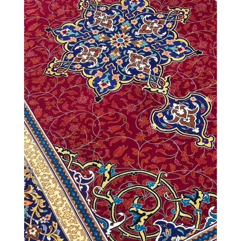Handcrafted Persian Isfahan Rug - Close-up angle of a Persian rug showing detailed floral motifs and knot work on a vibrant red background with intricate borders in blue and gold.