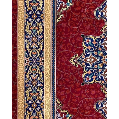 Handmade Persian Rug from Isfahan, Iran - An angled shot of a Persian rug displaying the rich red background with golden floral patterns and a complex blue medallion in the center.