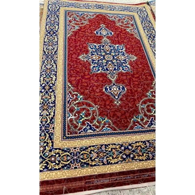 Wool and Silk Persian Area Rug - A close-up of the borders of a Persian rug, showcasing its intricate blue and gold patterns with floral motifs on a red base, woven with silk and wool.