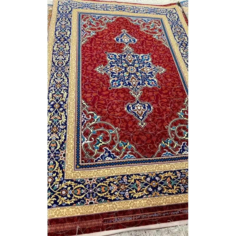 Wool and Silk Persian Area Rug - A close-up of the borders of a Persian rug, showcasing its intricate blue and gold patterns with floral motifs on a red base, woven with silk and wool.