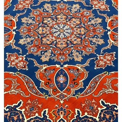 Hand-knotted Persian rug in a bold orange and blue palette, showcasing traditional Isfahan artistry.
