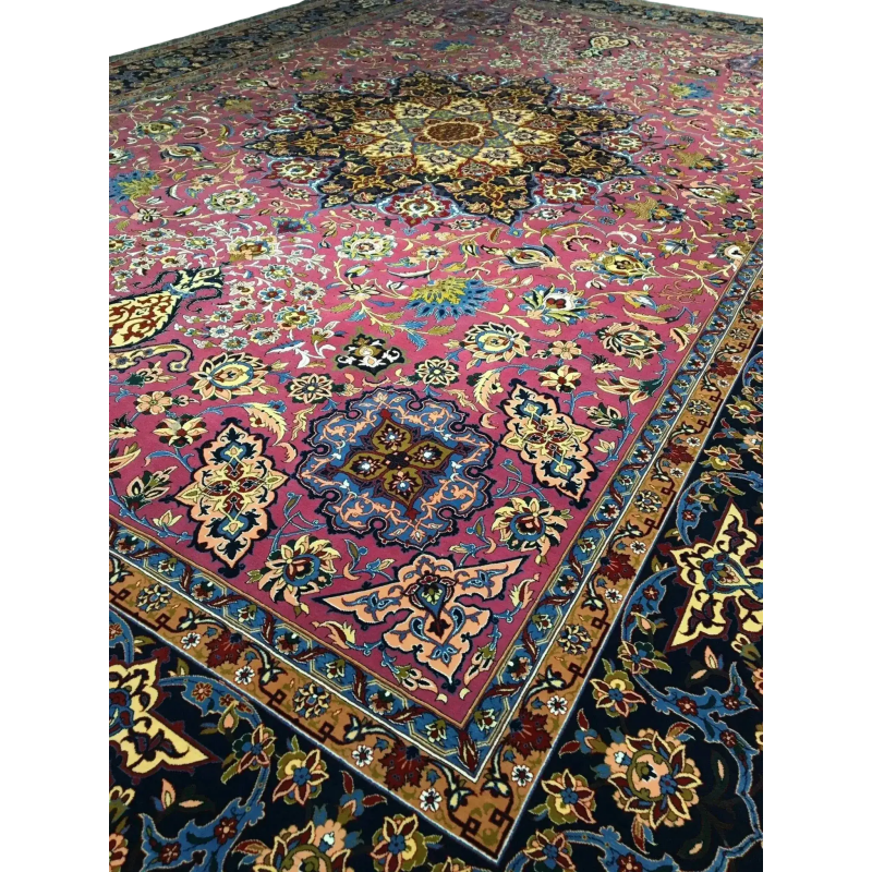 Close-up of the floral motifs and knot details on the purple area rug, showcasing a harmonious blend of purple, blue, and gold tones.
