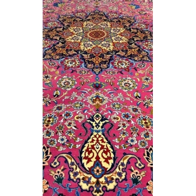 Detailed corner view of the purple oriental rug, showcasing a vibrant mix of colors and intricate floral designs against a purple background.