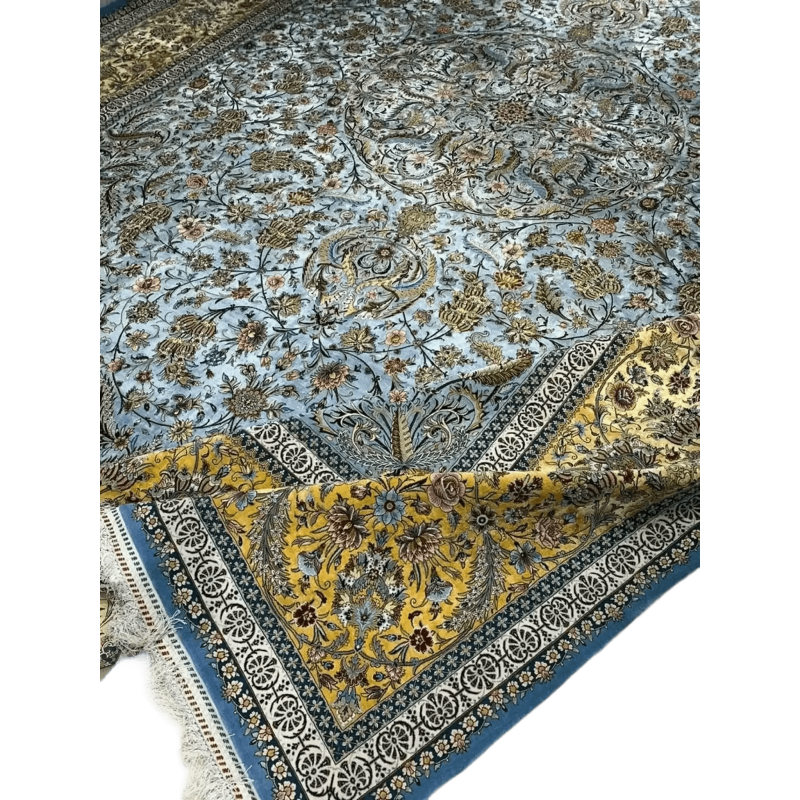 "Luxurious Persian carpet in delicate shades of blue and gold, crafted by master weavers with intricate floral designs from Isfahan, Iran."