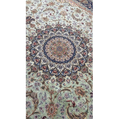 "Close-up of intricate knotwork on Persian silk rug, featuring a light green silk field."