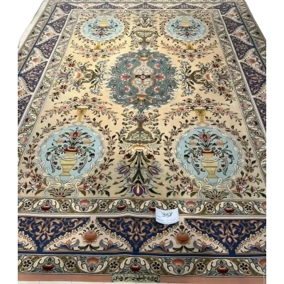 "Handmade Persian rug by Master Moeidie with intricate floral designs in soft beige and pastel tones."
