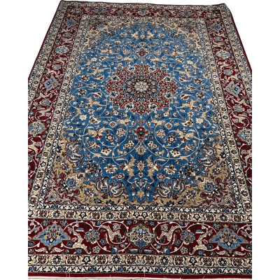Detail shot of the hand-knotted craftsmanship of the Authentic Isfahan Rug with a focus on the blue and red design