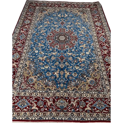 Detail shot of the hand-knotted craftsmanship of the Authentic Isfahan Rug with a focus on the blue and red design