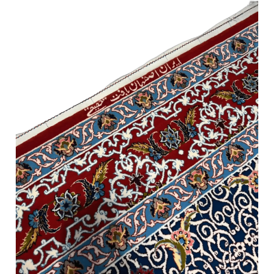 Detailed view of a Haghighie rug featuring red and blue traditional motifs