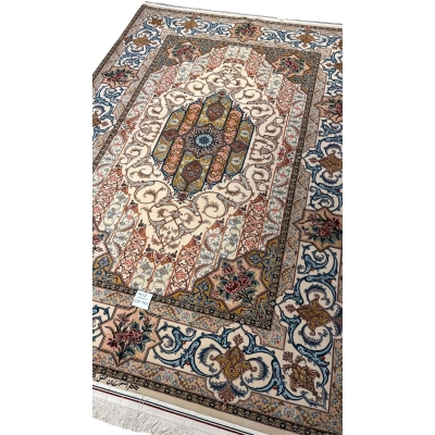 "Traditional handwoven Persian rug from Isfahan, showcasing an ornate floral medallion and elegant vine scrolls."