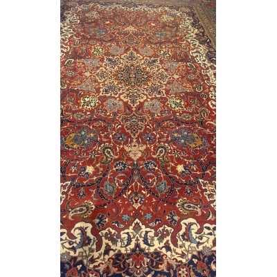 "100-year-old Isfahan rug with natural dyes, showcasing classic Persian craftsmanship and medallion design"