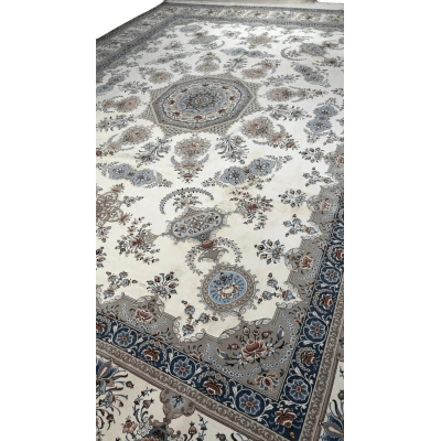 Side view of a luxurious Isfahan rug showcasing the dense knot work and the delicate floral design in shades of cream and blue.
