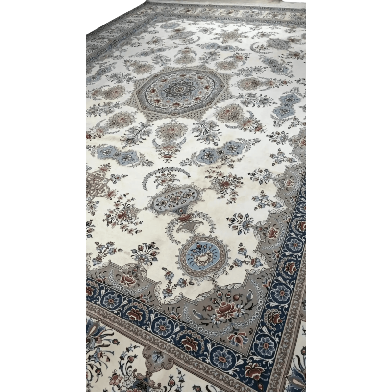Side view of a luxurious Isfahan rug showcasing the dense knot work and the delicate floral design in shades of cream and blue.