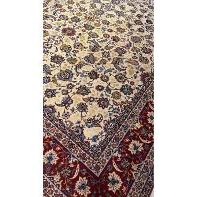Detailed view of an oriental rug with prominent red edging and subtle blue accents