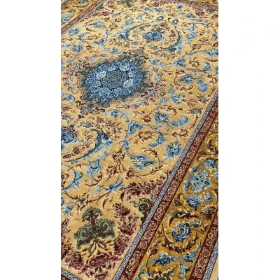 Elegant Mohaghegh silk carpet featuring blue and golden motifs