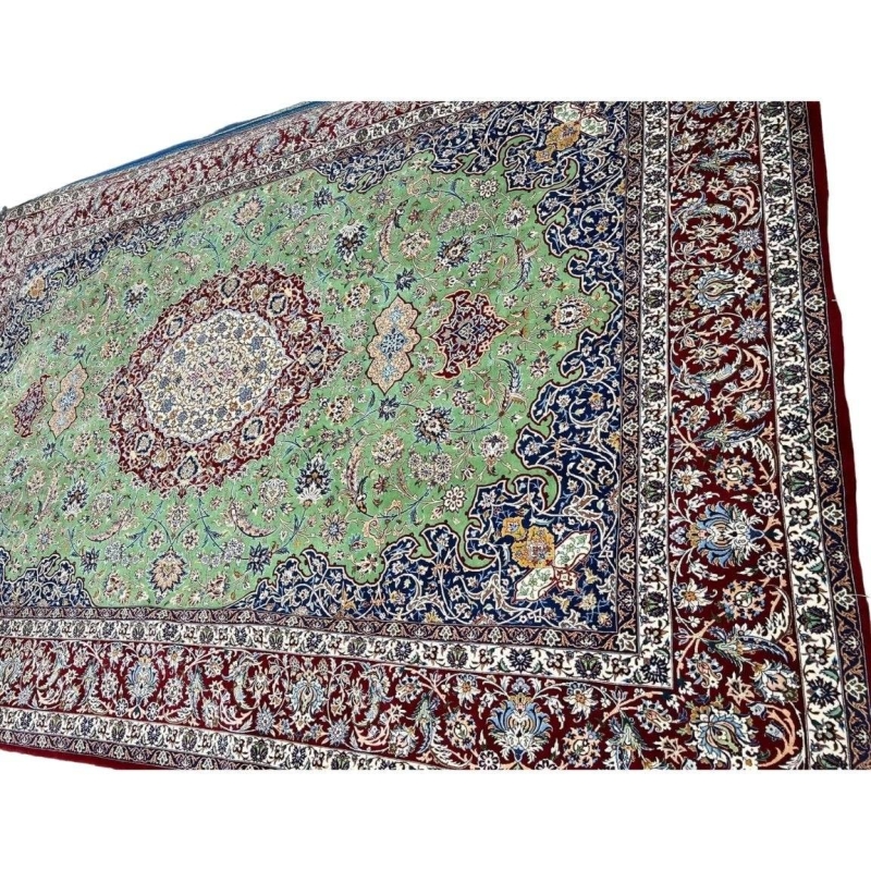 "Close-up of traditional design in master oriental weaver rug, green and red hues"