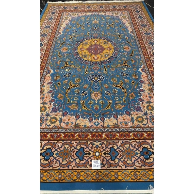 "Detailed view of the Persian rug's floral border design, highlighting the craftsmanship of Master Haghighie."