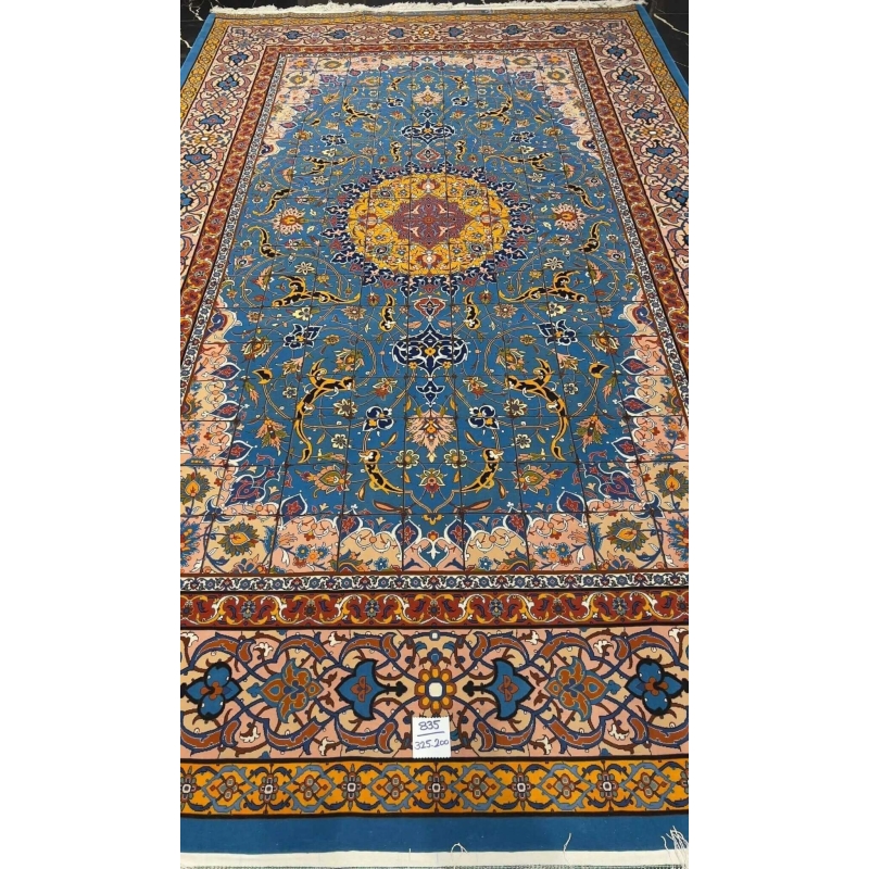 "Detailed view of the Persian rug's floral border design, highlighting the craftsmanship of Master Haghighie."