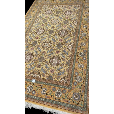 Master Weaver Haghieghie's wool and silk carpet featuring gold and blue motifs