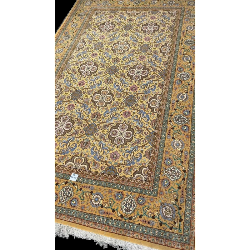 Master Weaver Haghieghie's wool and silk carpet featuring gold and blue motifs