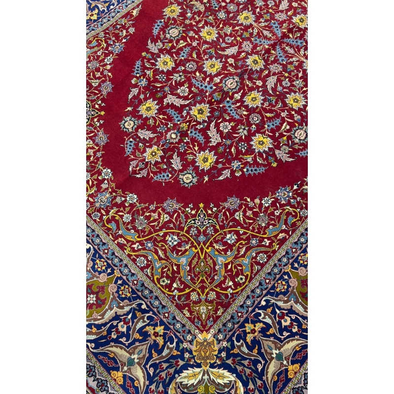 "Detailed view of antique red rug from Isfahan with intricate floral motifs"