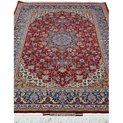 "Handwoven Isfahan rug by Master Bagher Seirafian with red, navy, and cream tones."